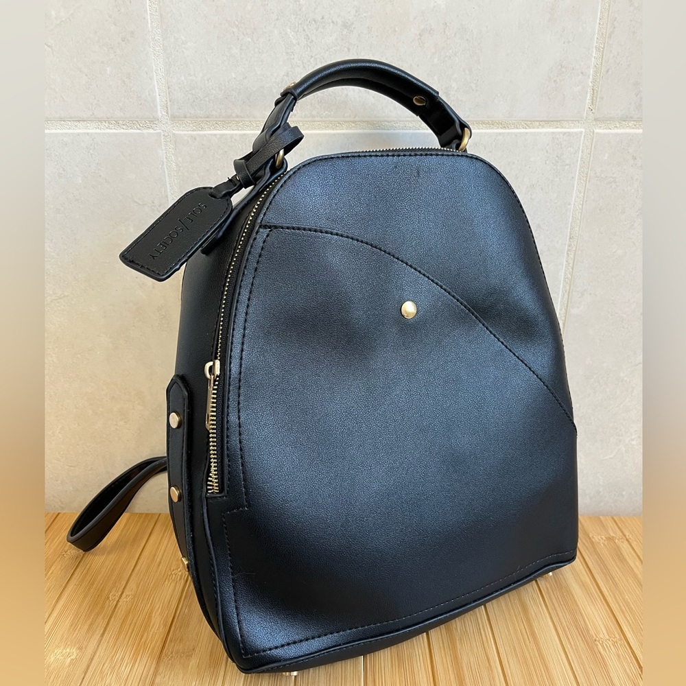 Sleek black backpack with animal print lining and gold hardware